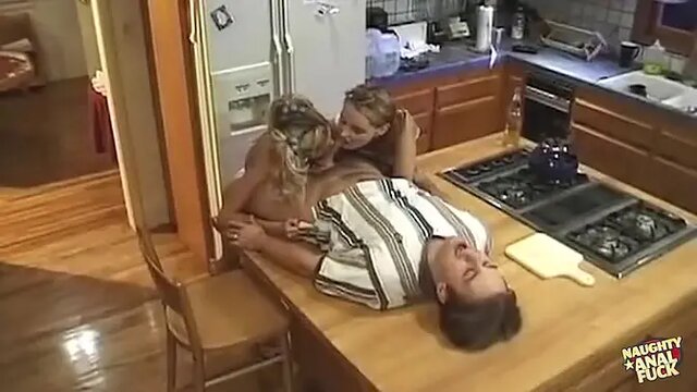 Two green blondes gang up on one lucky guy for anal threesome in the kitchen